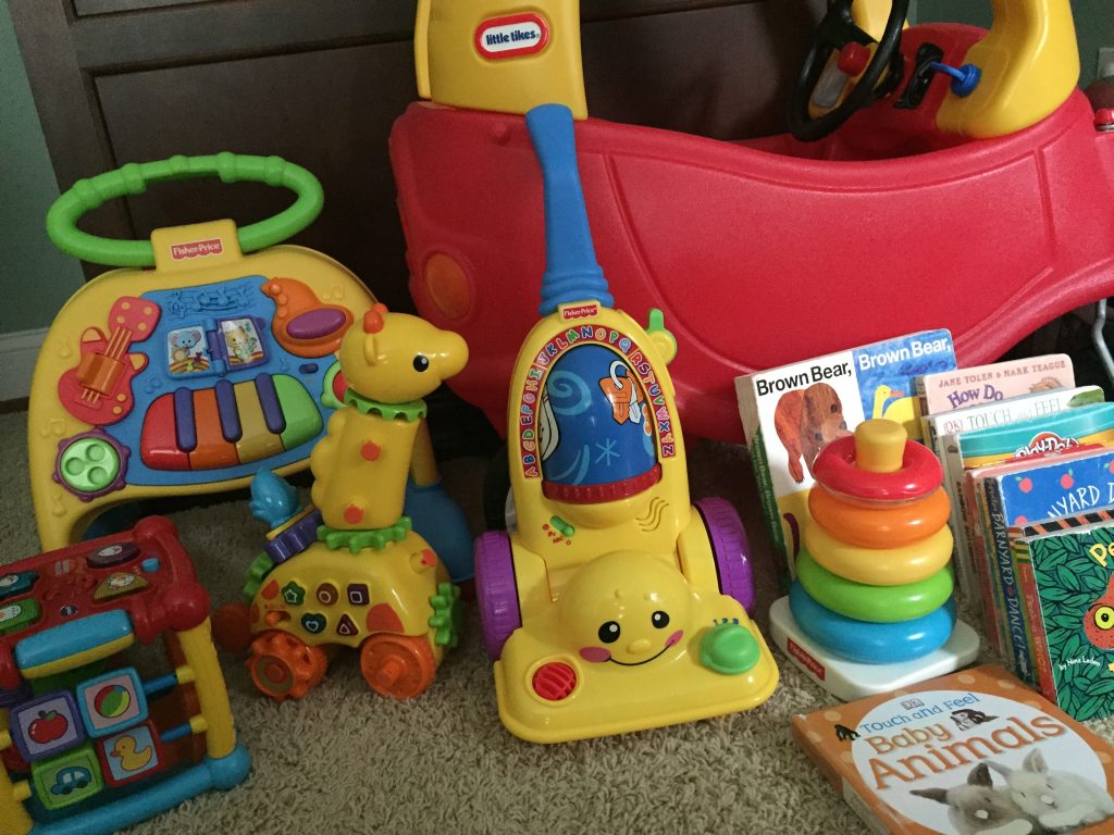 playroom filled with toys and books, including little tikes car