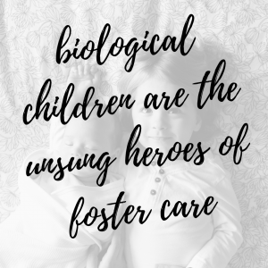 graphic text: "biological children are the unsung heroes of foster care" over black and white faded image of two young children laying on bed looking up