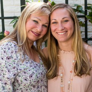 Two blonde women, mother and daughter smiling