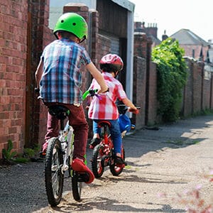 2 kids riding bicycles