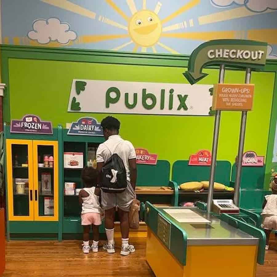A brother and sister playing store