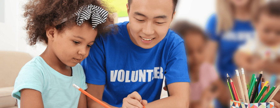 A volunteer tutor helping a child